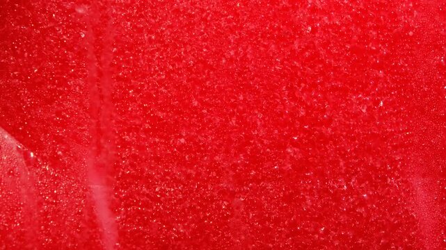 Drops of condensation on the red ice cream tank. Ice cold sorbet machine mixing fruit juice. 