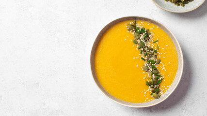 Creamy butternut squash soup with pumpkin seeds and sesame. Copy space