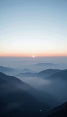 Fototapeta premium Mesmerizing Mountain Landscape with Layers of Misty Valleys Under a Tranquil Sunrise Sky Creating a Breathtaking Horizon View