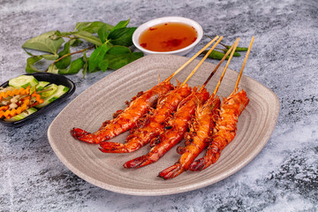 Grilled prawn skewer served sauce