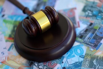 Kuwaiti dinar currency money bills and wooden judge mallet. The concept of judgment or auction