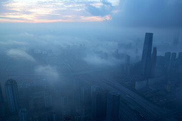 Fototapeta premium A breathtaking top view of the urban skyline of Jinan, China, shrouded in a gentle fog.