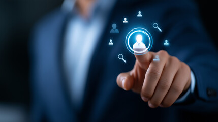 A businessman presses a glowing button on a futuristic HR dashboard recruitment icons of profiles and magnifying glasses expand outward in luminous blue. The scene radiates precis