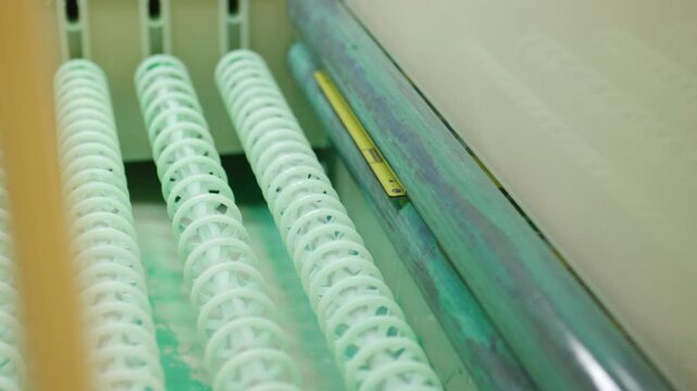 Automated machinery transports printed circuit boards through an electronics manufacturing facility, highlighting the precision and efficiency of modern industrial processes