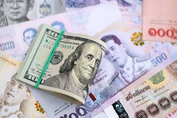 Thai baht currency money bills and bunch of us dollars. The concept of currency exchange