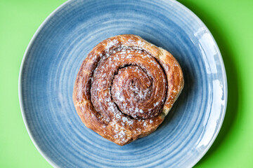 Single Cinnamon Swirl Breakfast Pastry Served On A Plate