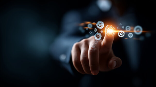 A businessman in a dark suit reaching toward a glowing holographic button bright icons of automation gears spinning outward across a digital interface atmosphere of futuristic