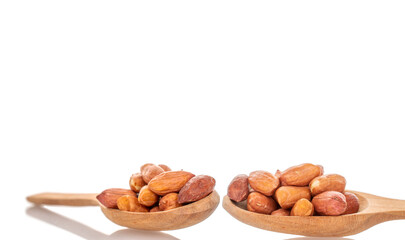 Peeled raw peanuts isolated on white background, close-up.