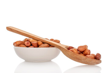 Peeled raw peanuts isolated on white background, close-up.