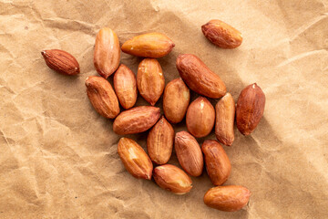 Obraz premium Peeled raw peanuts, top view, macro.