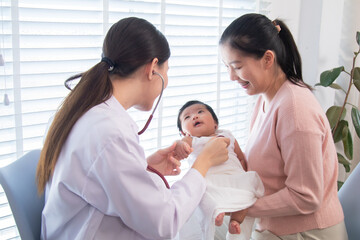 Fototapeta premium Newborn baby with mother during pediatric checkup, female doctor using stethoscope for medical examination, healthcare service, family bonding, protection, illness, and wellness in clinic environment