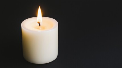 A single white candle with a flickering flame.
