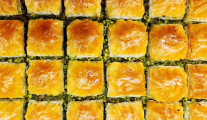 Square baklava, unique to Gaziantep, Turkey, is a traditional Turkish dessert prepared with very thin layers of phyllo dough and Antep pistachios, with syrup poured over it after it's baked