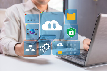 A person interacts with digital icons representing data management, cloud storage, and security on a smartphone and laptop, illustrating modern technology use.