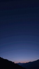 Fototapeta premium Silhouetted Mountain Range Under a Tranquil Starlit Sky at Twilight Capturing the Peaceful Transition from Day to Night in a Serene Natural Landscape