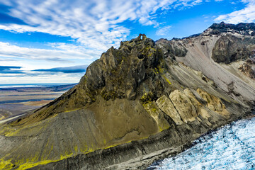 Volcanic mountain ridge and glacier in Iceland, aerial landscape