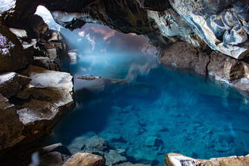 Grj&oacute;tagj&aacute; lava cave hot spring in Iceland with blue geothermal water