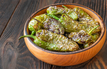 Terracotta bowl of Pimientos de Padron sprinkled with coarse sea salt