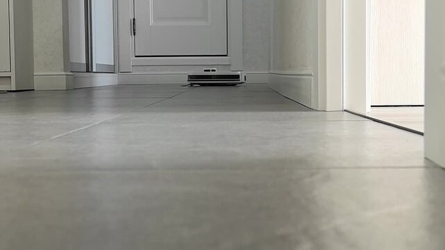 Robot Vacuum Cleaner Moving on Tile Floor