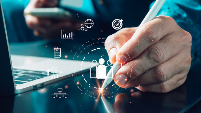 A professional uses stylus on digital interface to manage business team, analyze strategy,review data.This image represents modern team management, HR, communication, organization planning technology.