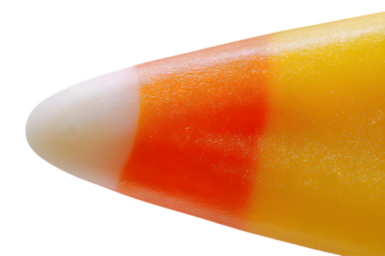 Closeup macro shot of a single candy corn sweet isolated on transparent background, showing its distinct white, orange, and yellow layers