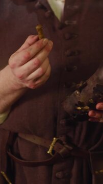 Merchant studies stick and pays attention to guest in shop. Smiling bartender tries to serve customer best in magic potion ingredients store. Medieval trader