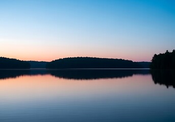 Fototapeta premium Calm lake at dusk with colorful sky reflection on water