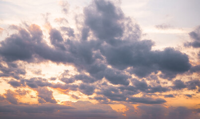 Colorful clouds fill the sky at sunset over a tranquil horizon near the coast