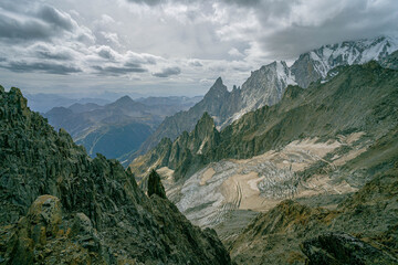 Towering alpine spires and rugged glacier landscape under overcast sky in the Alps capturing dramatic mountain wilderness and panoramic views