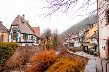 Colorful Christmas decorations adorn the quaint buildings and market stalls, creating a festive atmosphere in the city during the holiday season.