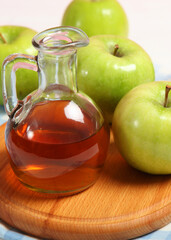 apples and apple cider vinegar on the table.. Vertical photo format