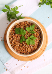 boiled buckwheat in a plate on the table.. Vertical photo format
