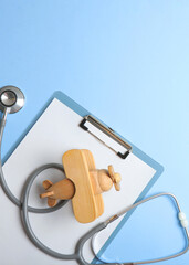  Pediatrics concept. Stethoscope and toy on a light background. Vertical photo format