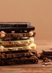 Chocolate products of different types on a colored background close-up with a place for text . Vertical photo format