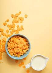 Golden and crunchy cornflakes on a colored background close-up. Vertical photo format