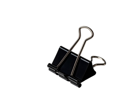 A black metal binder clip, angled, against a black background