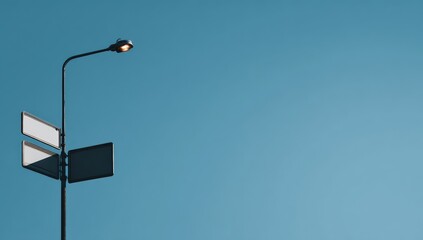 Streetlamp and signs against a clear sky