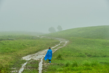 Walking through a misty windswept meadow in Meghalaya