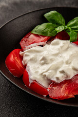 Salad strachatella and tomato portion size natural product tasty snack fresh delicious gourmet food background on the table rustic top view copy space keto and paleo diet