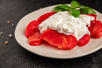 Salad strachatella and tomato portion size natural product tasty snack fresh delicious gourmet food background on the table rustic top view copy space keto and paleo diet