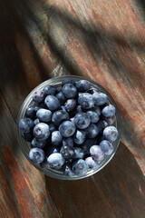 Blueberries in bowl on a wooden