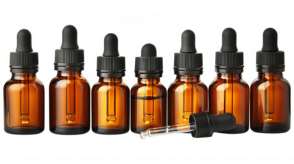 Amber Dropper Bottles in Line: A precise alignment of amber dropper bottles, meticulously arranged to showcase their individual glass forms with an open dropper at front.