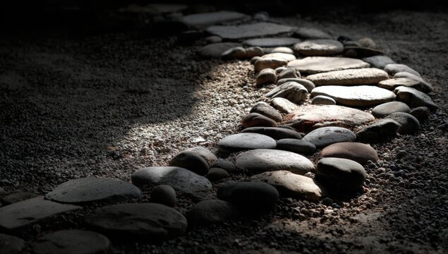 Stone path winding through dark ground - Powered by Adobe