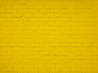 Textured yellow brick wall with uneven surface. Rough and grunge texture. Brick painted with yellow...