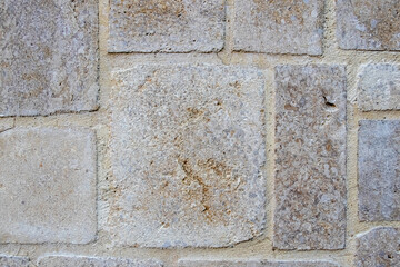 Fototapeta premium Stone wall texture with large rectangular gray beige blocks for architectural design and construction projects