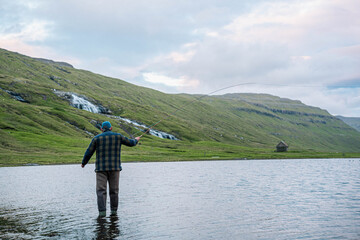 Man Fly Fishing in Mountain Lake on the Faroe Islands
