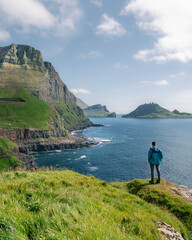 man on the mountain, Faroe Islands, Vagar, Gasadalur village, cliffs