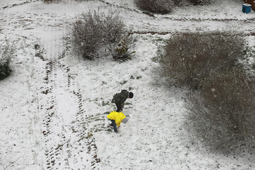 Children Playing in Snow-Covered Park in Winter Wonderland Scene