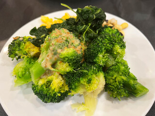 Fresh steamed broccoli served on white plate, showcasing healthy vegan meal, rich in vitamins, fiber, and antioxidants, perfect for clean eating, diet food, and nutritious vegetarian cuisine