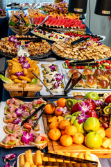 Tasty buffet of fruits and snacks. A vibrant buffet features a variety of dishes, including fruits, pastries, and savory snacks, perfect for any gathering.